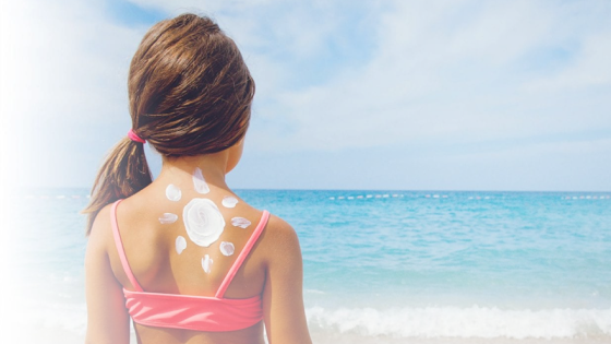 meisje op het strand met zonnebrand