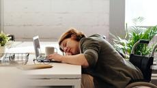 vrouw met ijzertekort valt achter bureau in slaap