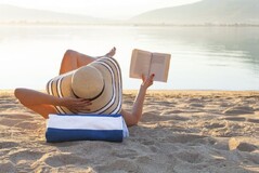 Vrouw liggend op strandhanddoek op het strand